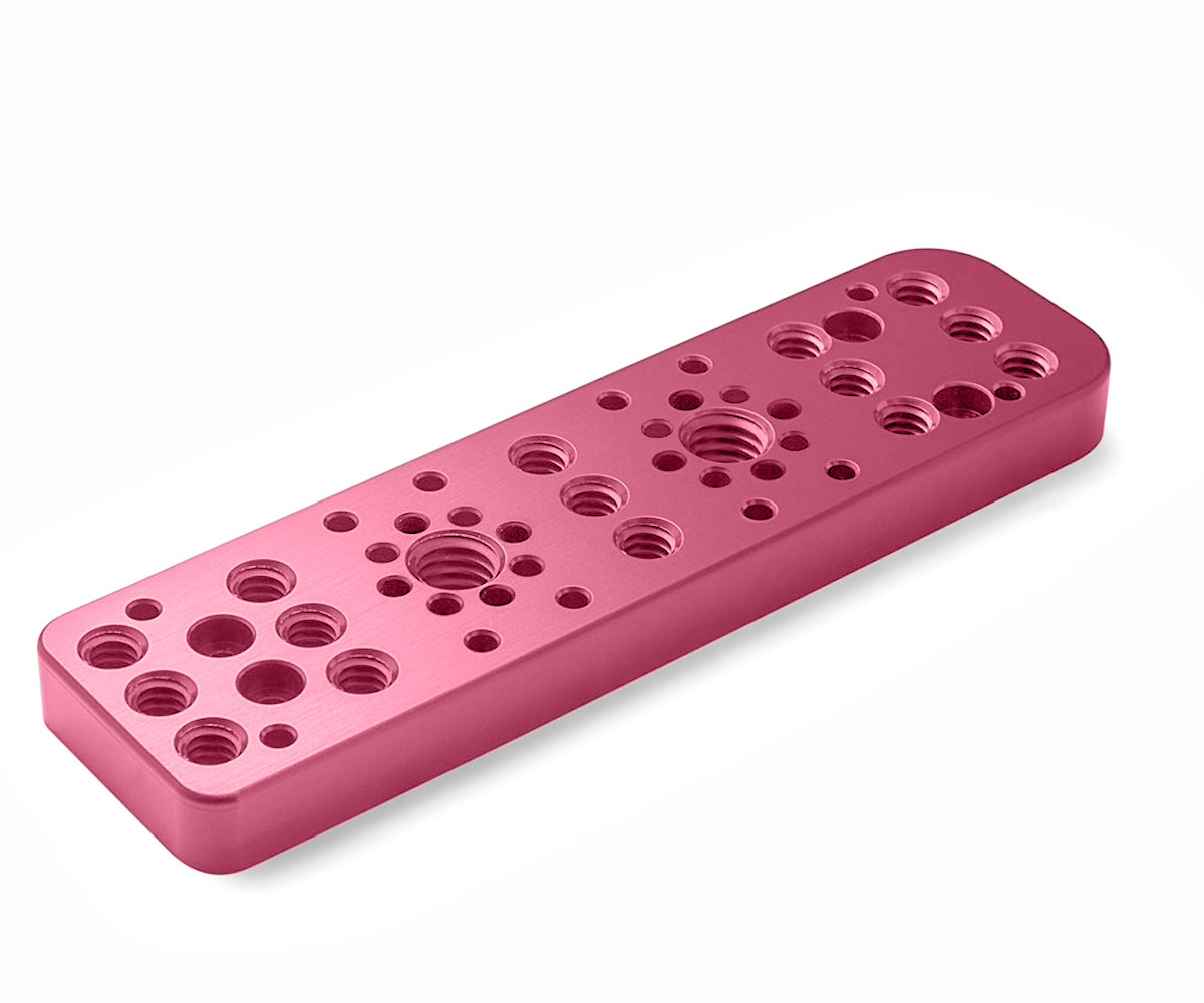 Bolex pink right side plate showcased on white background. Designed for door attachment on Bolex cameras.